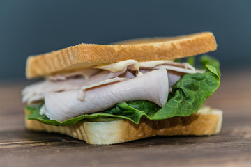 Fresh baguette sandwich on wooden background. Classic BLT sandwiches. Close up.