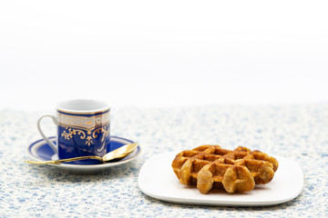 coffee and belgian waffle on flower pattern tablecloth