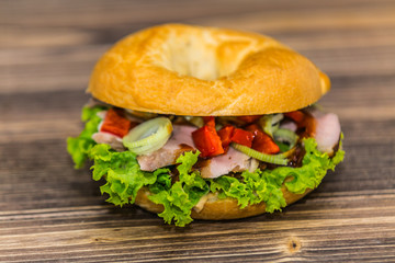 Fresh baguette sandwich on wooden background. Classic BLT sandwiches. Close up.