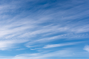 Hazy small cirrostratus, cirrocumulus and cumulus cloud formations at blue sky