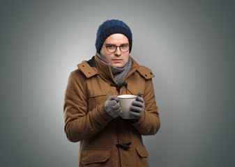 Handsome young boy freezing in warm clothing with copy space