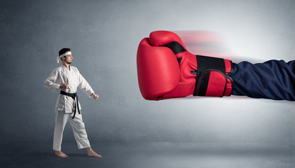 Little man fighting with a giant red boxing glove
