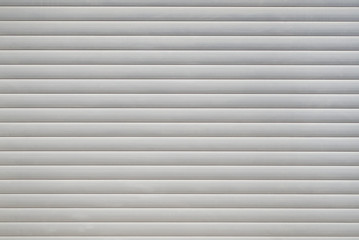 Obraz premium White textured background with horizontal stripes. Garage door.