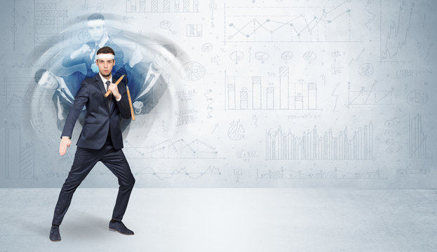 Young businessman in suit fighting with chart and report concept
