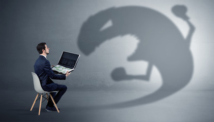 Young businessman staying and  negotiate with a monster shadow
