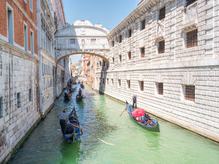 Fototapeta na wymiar Traditional gondolas floating on canal in Venice.