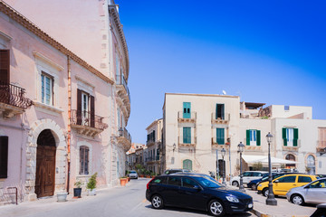 Fototapeta na wymiar View of old street, facades of ancient buildings in Ortygia (Ortigia) Island, Syracuse, Sicily, Italy, traditional architecture