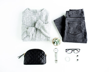 Women fashion clothes and accessories. Feminine youth collage on white background top view. Flat lay female style look with warm sweater, jeans, glasses. Top view.