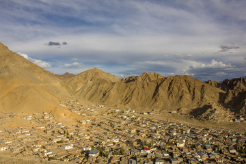 village at the foot of the mountain sand desert