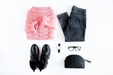 Women fashion clothes and accessories. Feminine youth collage on white background top view. Flat lay female style look with warm sweater, jeans, boot, glasses. Top view.