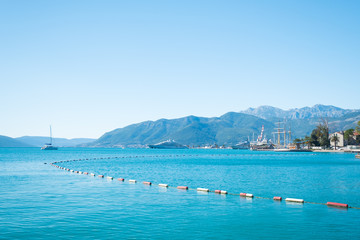 Sailboats and power boats anchored in crystal clear turquoise waters in the Caribbean