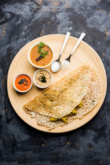 Onion rava masala dosa is a South Indian instant breakfast served with chutney and sambar over...