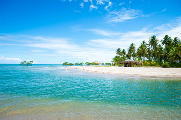 Scenic landscape view of rustic beach bar on empty tropical beach on a remote island in northeast Bahia, Brazil