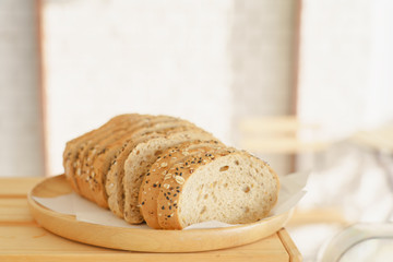 Slices bread and delicious croissant on wooden table background. Breakfast concept.