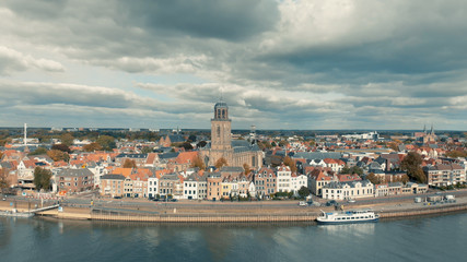 Fototapeta na wymiar Aerial panoramic view of the Dutch medieval city of Deventer in The Netherlands seen from the other side of the river IJssel that passes it