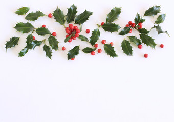 Christmas holly with red berries. Traditional festive decoration. Holly branch with red berries on...