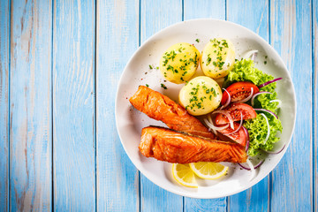 Grilled salmon with boiled potatoes, asparagus and vegetable salad