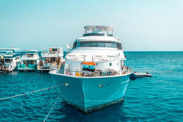 Obraz premium A large private motor yacht under way sailing out on tropical sea. Luxury yacht.