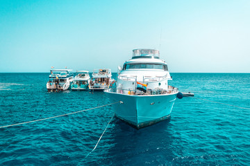 A large private motor yacht under way sailing out on tropical sea. Luxury yacht.