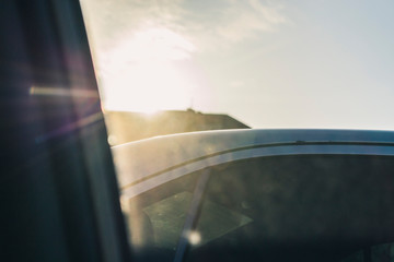 The sun's rays hit the car through the glass