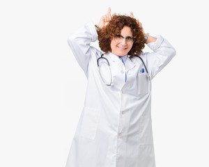 Middle ager senior doctor woman over isolated background Posing funny and crazy with fingers on head as bunny ears, smiling cheerful