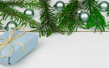 Christmas presents with a spruce twig and decorations on a white background.