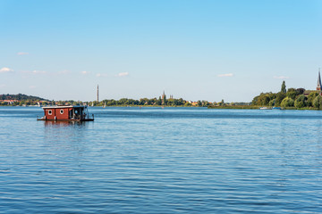 Naklejka premium Houseboat on the river Havel southerly from Berlin. The river forms several lakes in the state of Brandenburg, Germany