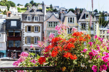 Fototapeta na wymiar Picturesque flowers with old houses in background, Morlaix, France