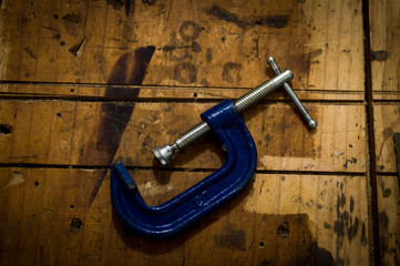 joiner's clamp metal blue on work bench woodworking