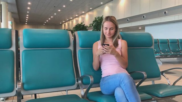 woman at the airport using the phone