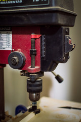 Red and black bench drill switch turns on seen close up