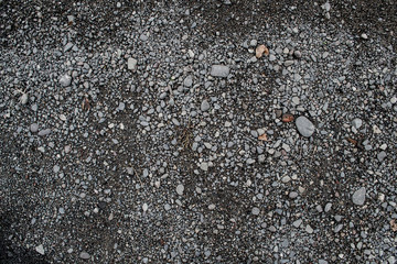 Texture of asphalt road with sand and stones and pits