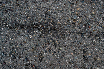 Texture of asphalt road with sand and stones and pits