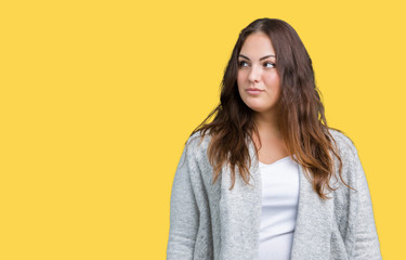 Beautiful plus size young woman wearing winter jacket over isolated background smiling looking side and staring away thinking.