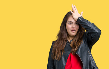 Beautiful plus size young woman wearing a fashion leather jacket over isolated background surprised...