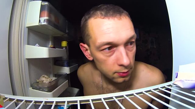 GUY CLIMBS AT NIGHT IN THE FRIDGE TO EAT