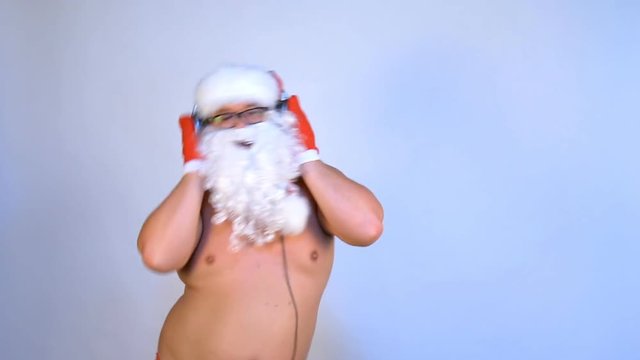 Funny Santa listens to music and dances.