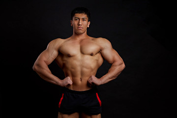 Bare powerful strong man with hands on hips. result of fitness trainings.closeup photo.wellness