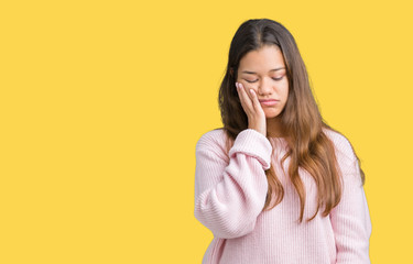 Young beautiful brunette woman wearing pink winter sweater over isolated background thinking looking tired and bored with depression problems with crossed arms.