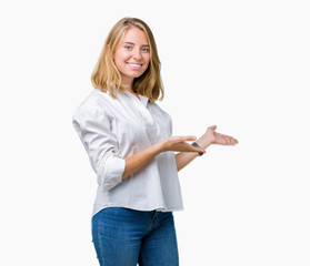 Beautiful young business woman over isolated background Inviting to enter smiling natural with open hand