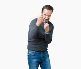 Handsome middle age senior man wearing a sweater over isolated background Ready to fight with fist defense gesture, angry and upset face, afraid of problem