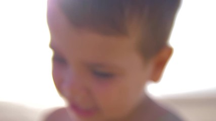 4K Slow motion - Caucasian Child with blue eyes looking at the camera in a sunny day