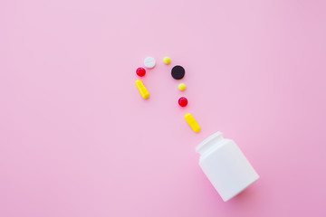 Close up of pills. Dietary supplements. Variety pills. Vitamin capsules on pink background