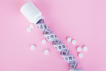 Close up of pills. Dietary supplements. Variety pills. Vitamin capsules on pink background