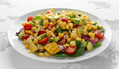 Sweet Corn salad with tomatoes, avocado, red onion, herbs and lime