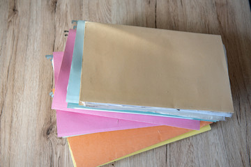 Stacked documents on the office desk.
