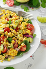 Sweet Corn salad with tomatoes, avocado, red onion, herbs and lime