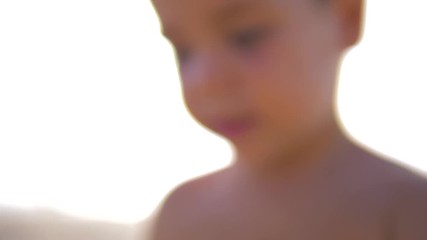 4K Slow motion - Caucasian Child with blue eyes looking at the camera in a sunny day