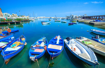 Obraz premium Fishing row boat in old harbor of Bari, region of Apulia, Italy.