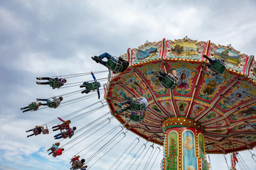 Carousel on cloudy sky background. Oktoberfest, Bavaria, Germany